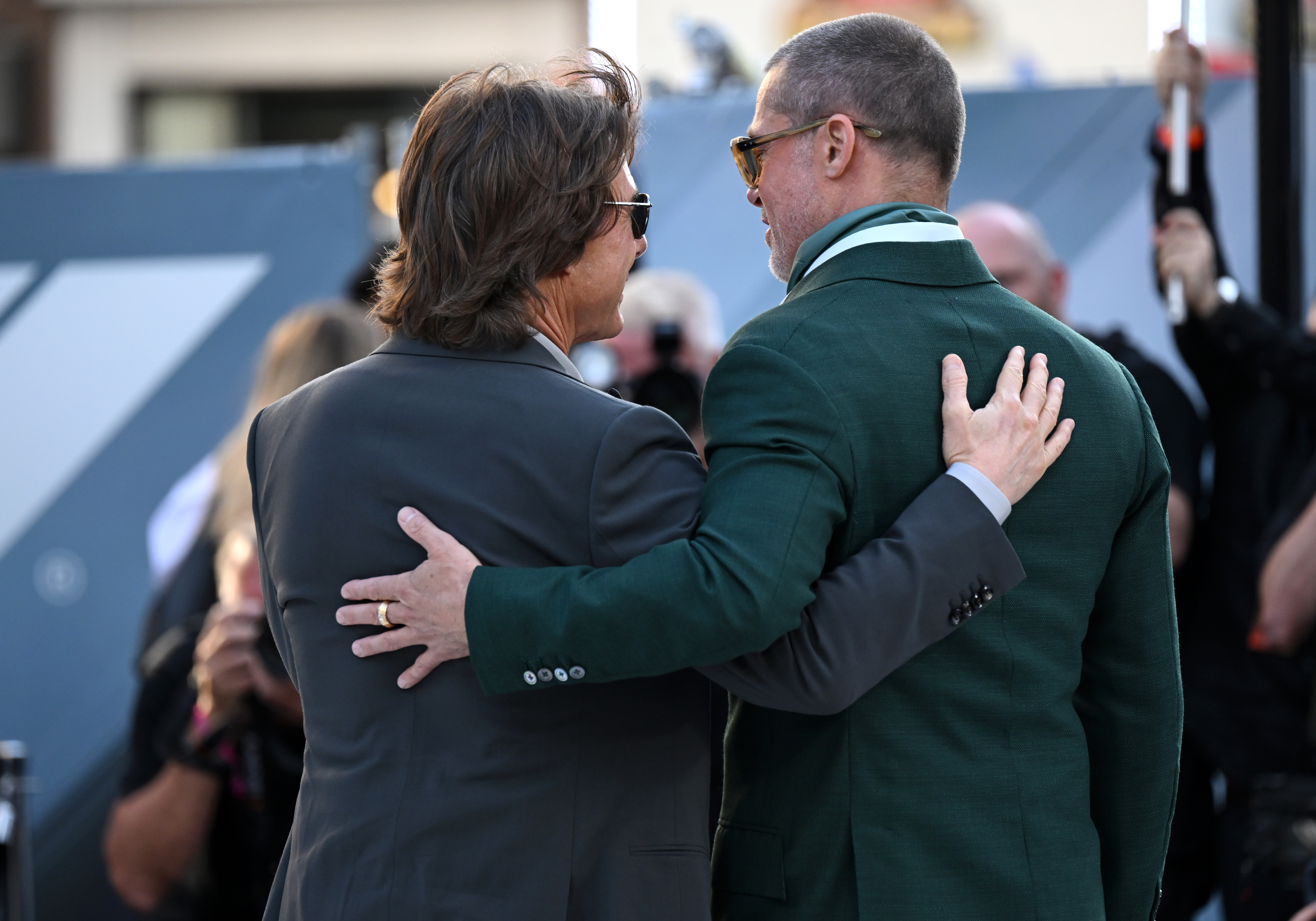 Brad Pitt and Tom Cruise pose arm in arm at the 'F1' London premiere.