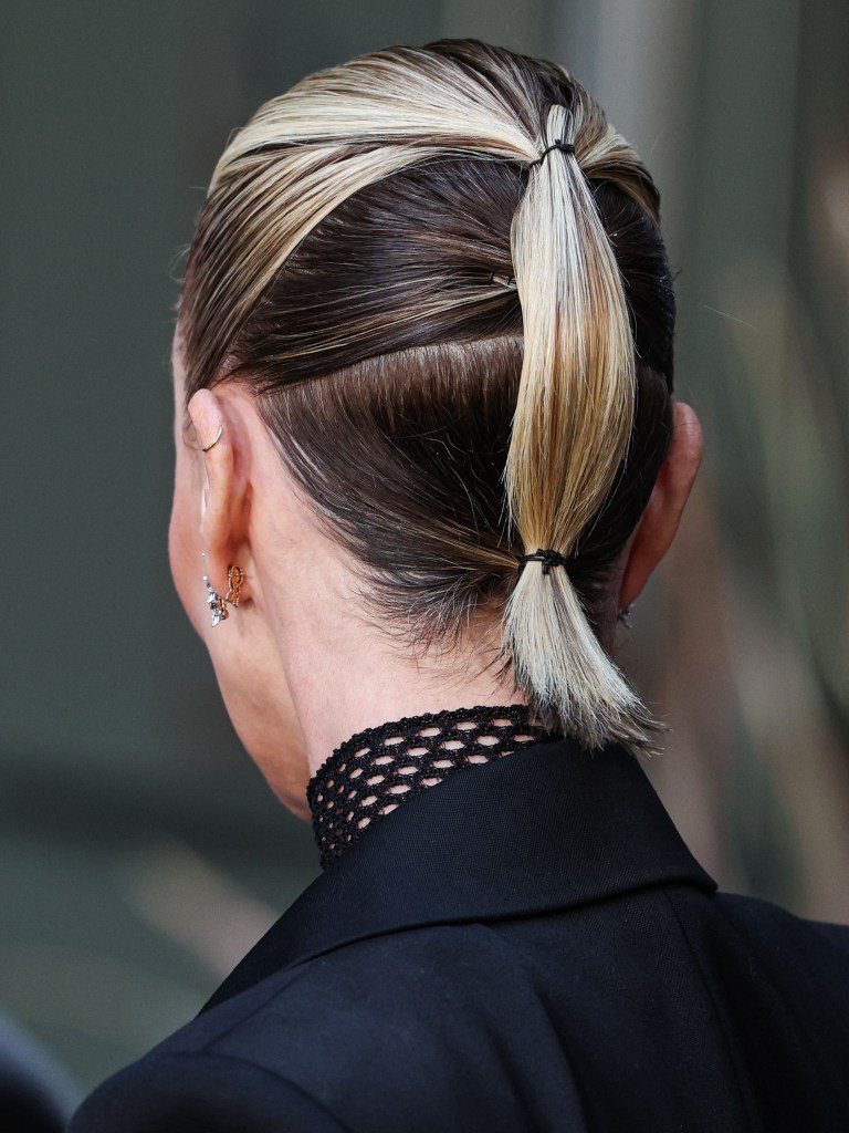Charlize Theron showcasing a stylish double ponytail.