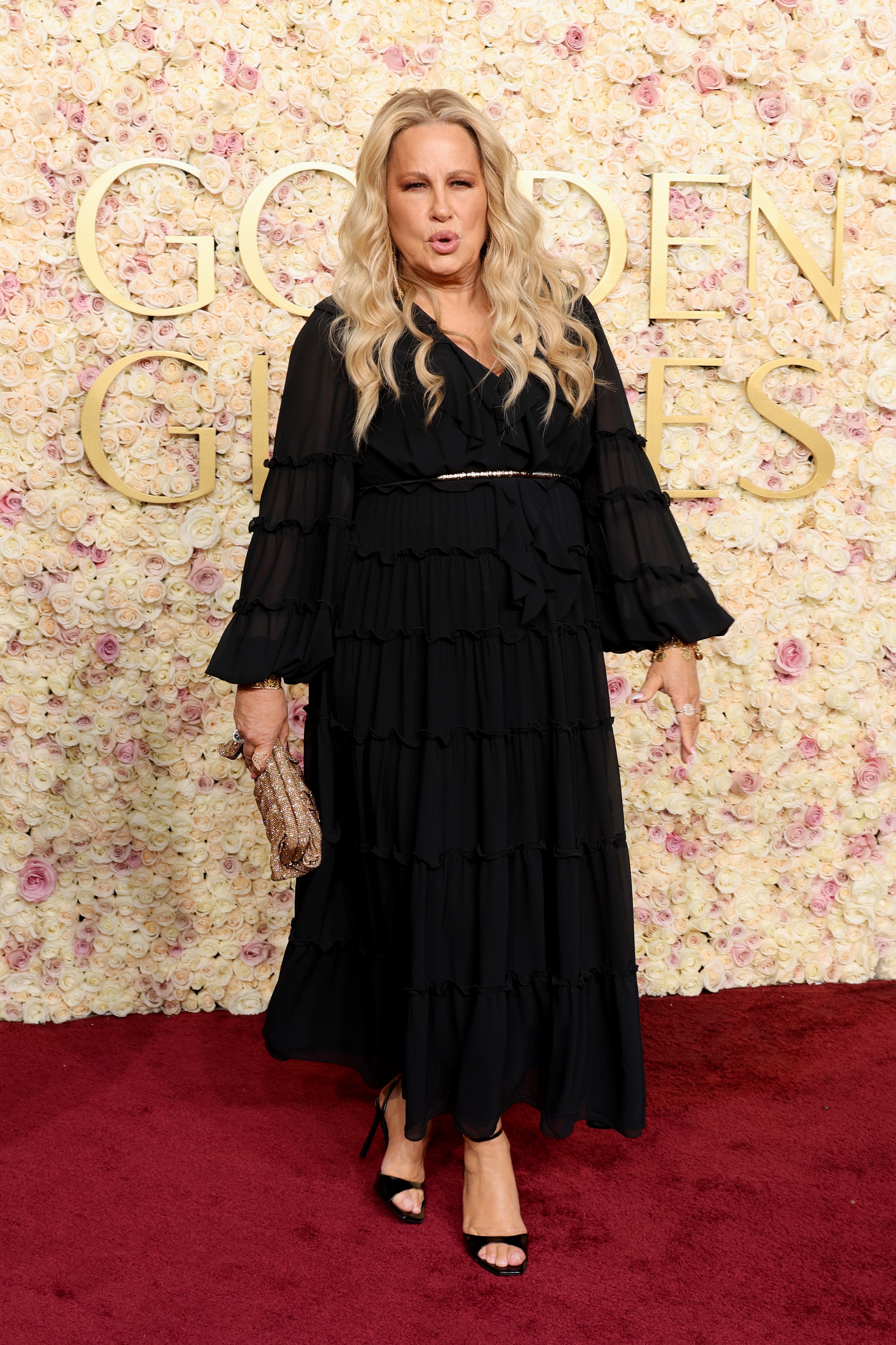 Jennifer Coolidge in a dark gown with a white belt at the Golden Globes. (Getty Images)