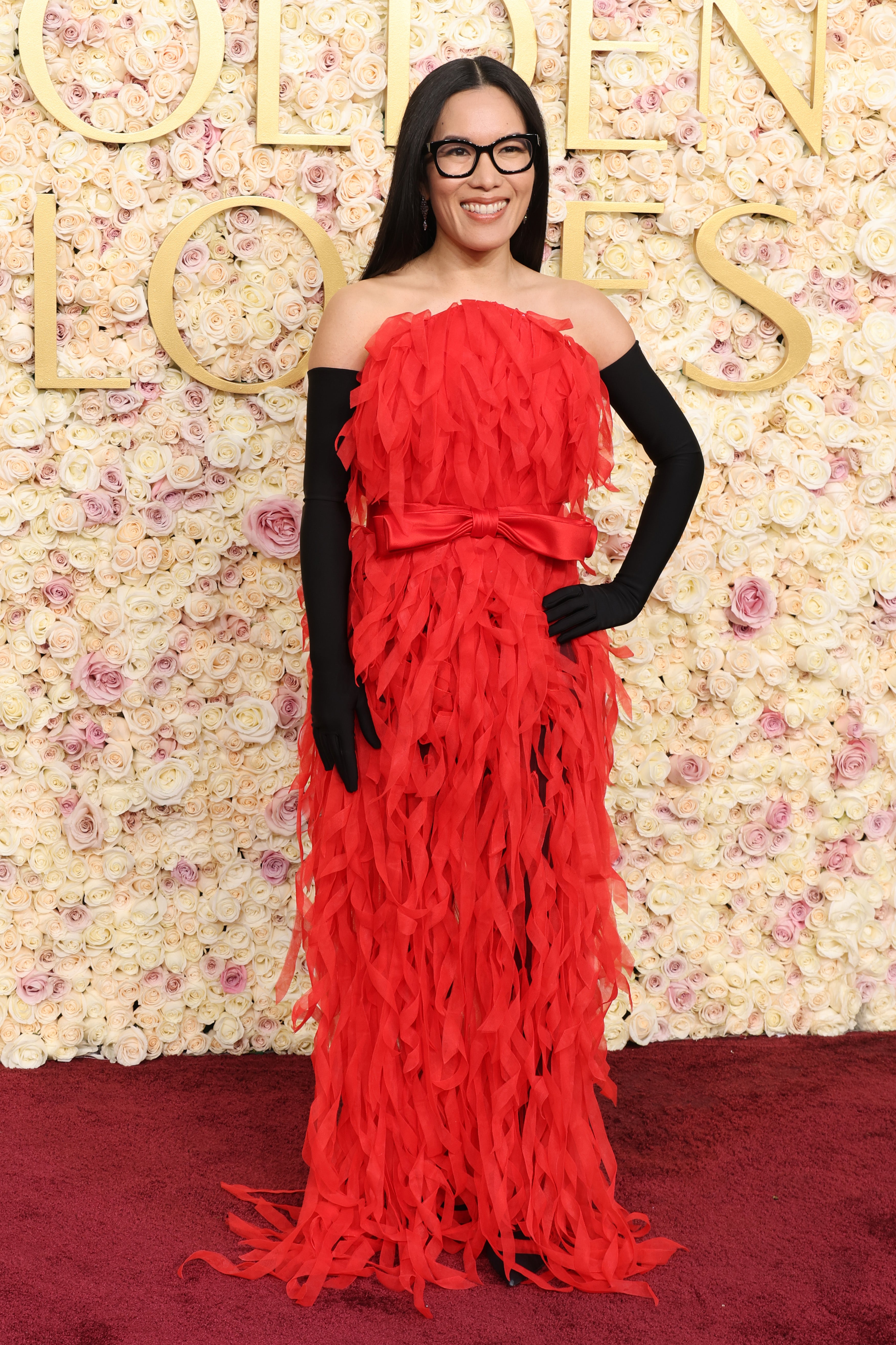 Ali Wong's red Balenciaga gown complemented with opulent accessories at the Golden Globes. (Getty Images)