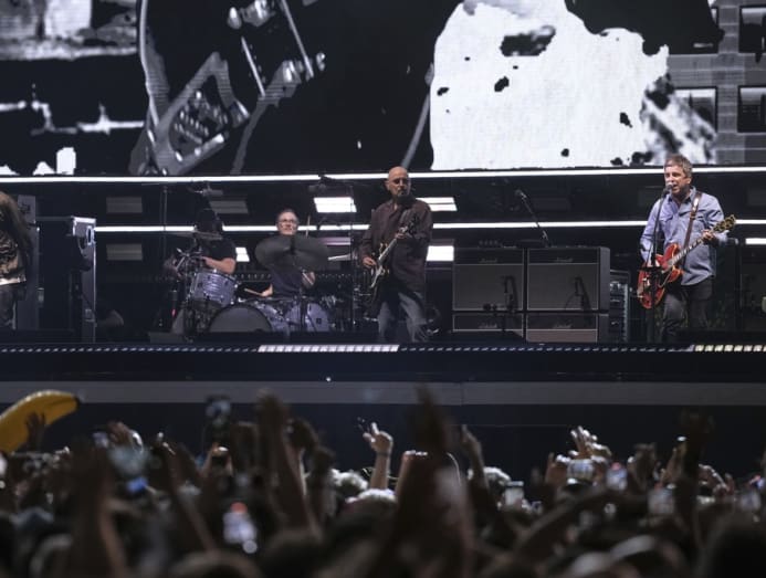 Liam and Noel Gallagher performing together in Cardiff