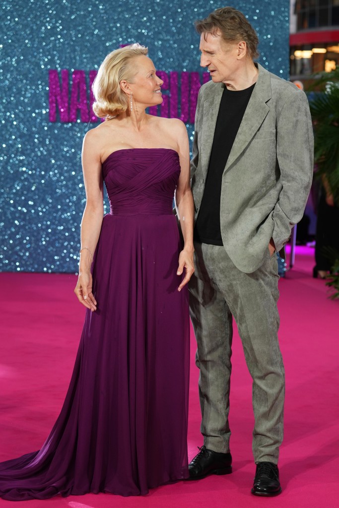 Pamela Anderson and Liam Neeson at the premiere, both smiling.
