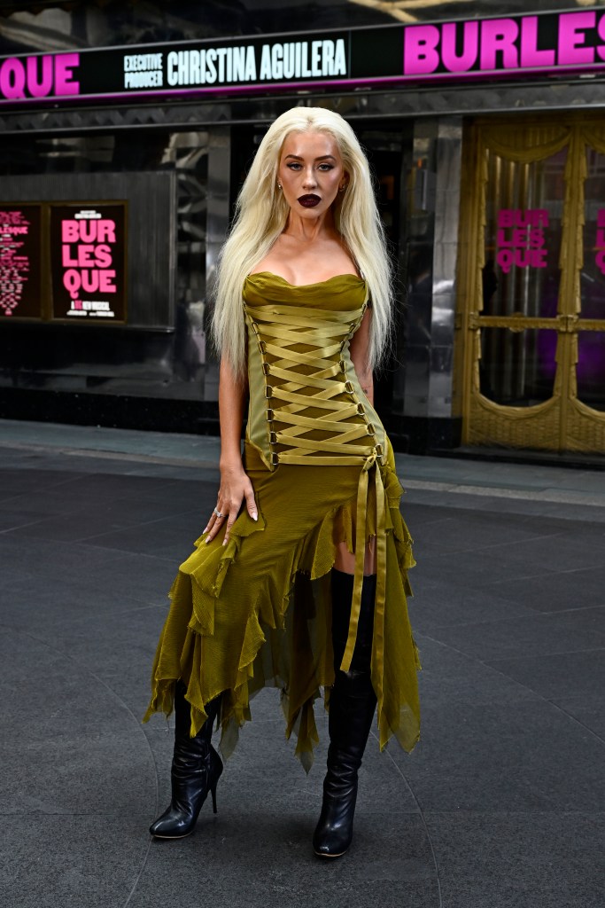 Christina Aguilera wearing a green lace-up Versace dress.
