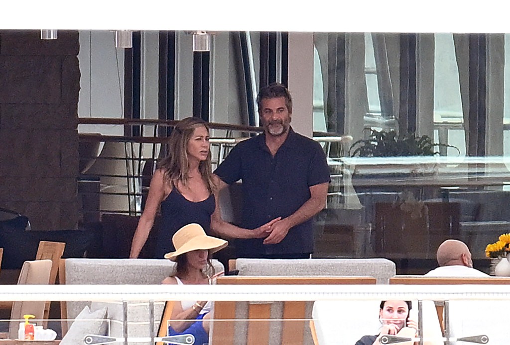 Jennifer Aniston and Jim Curtis sharing a tender moment on a yacht in Mallorca.