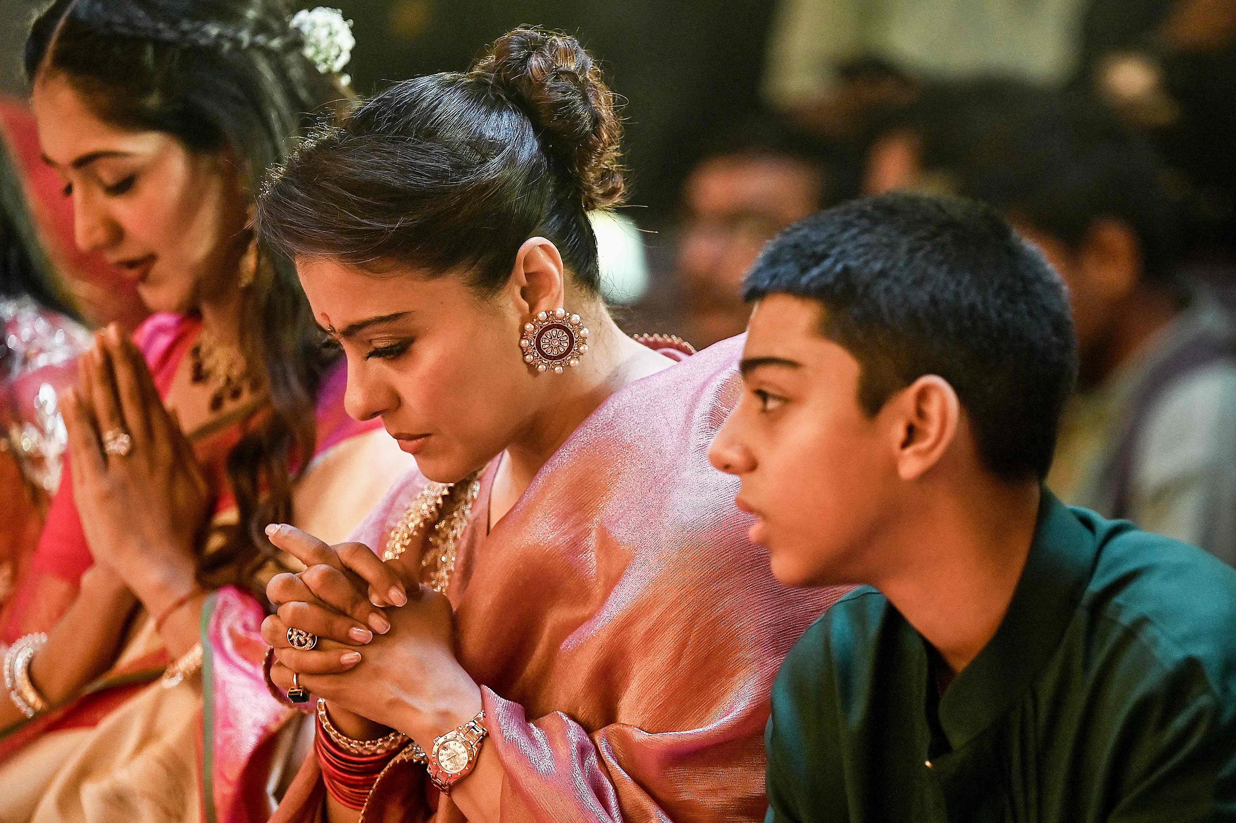 Kajol celebrates Durga Puja with her son, highlighting their festive traditions.