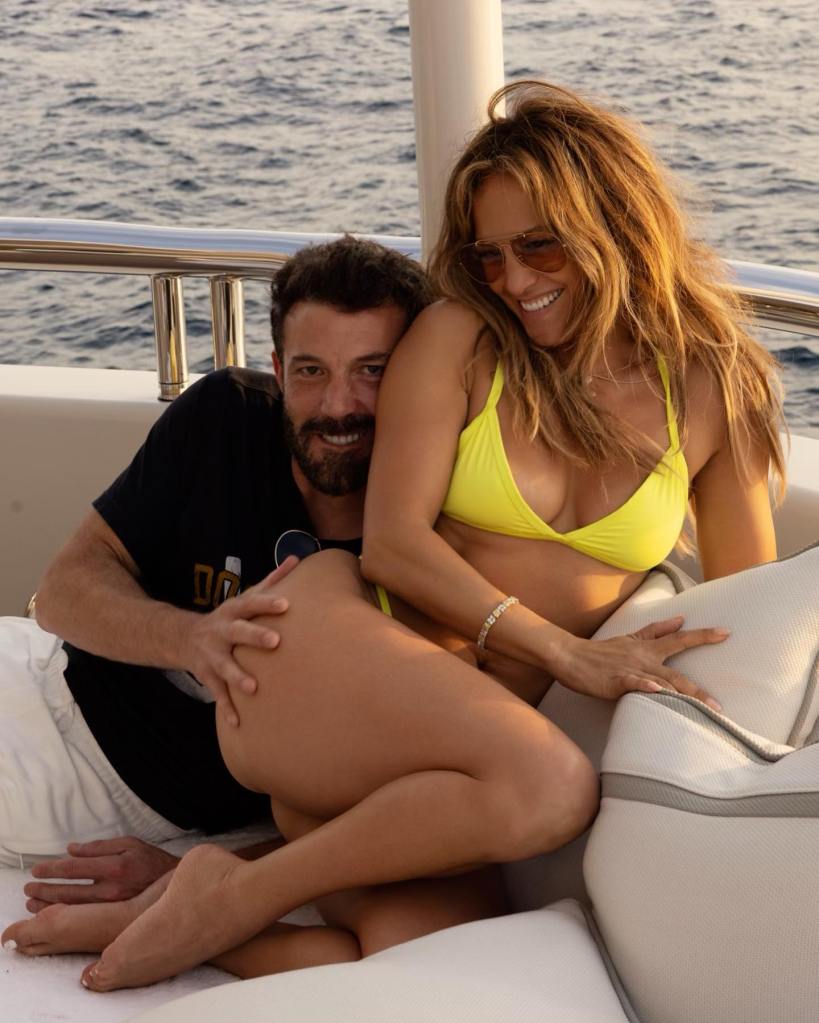 Jennifer Lopez and Ben Affleck smile on a boat.
