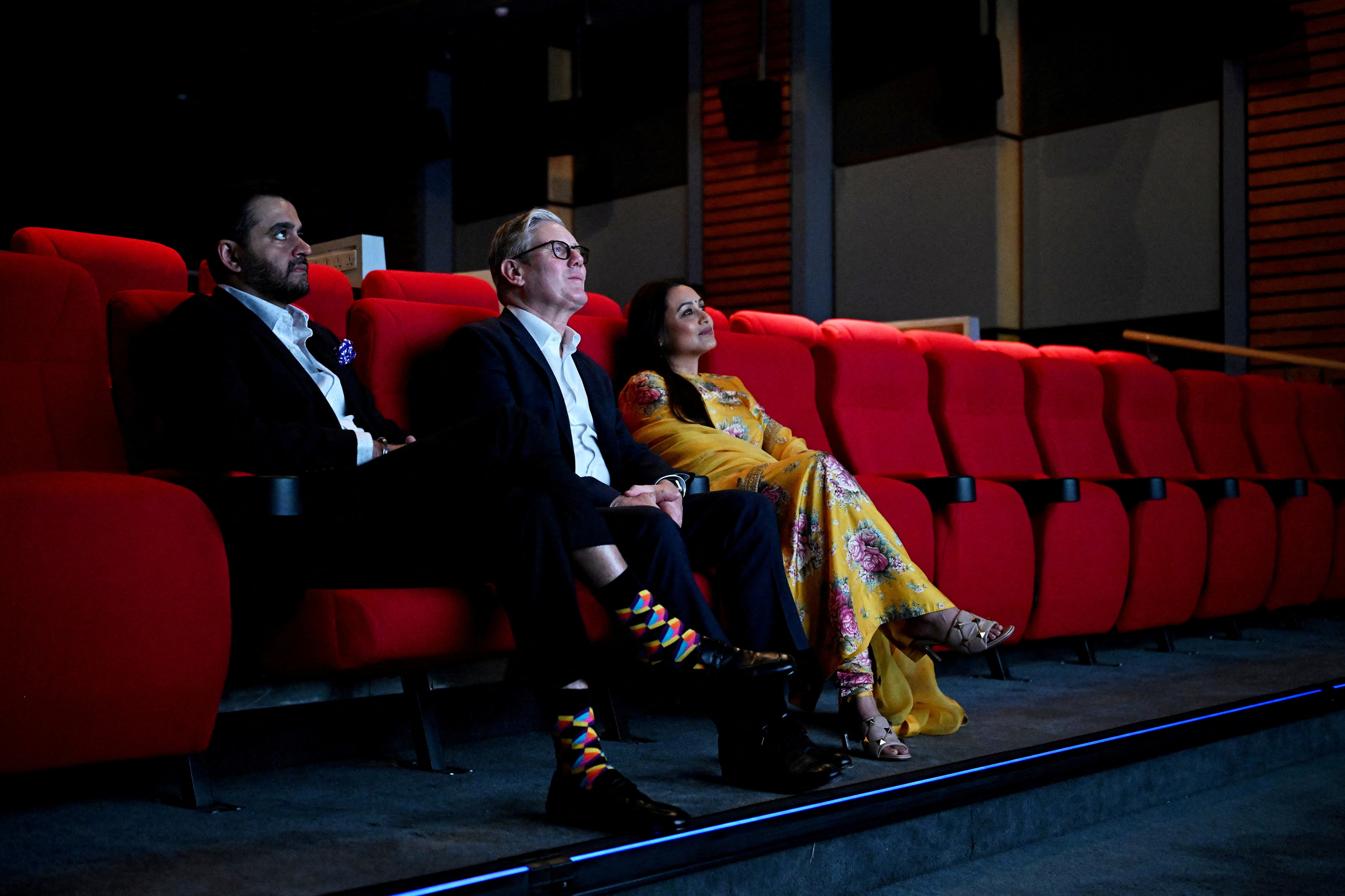 Yash Raj Films CEO, Keir Starmer, and Rani Mukerji screen a presentation.