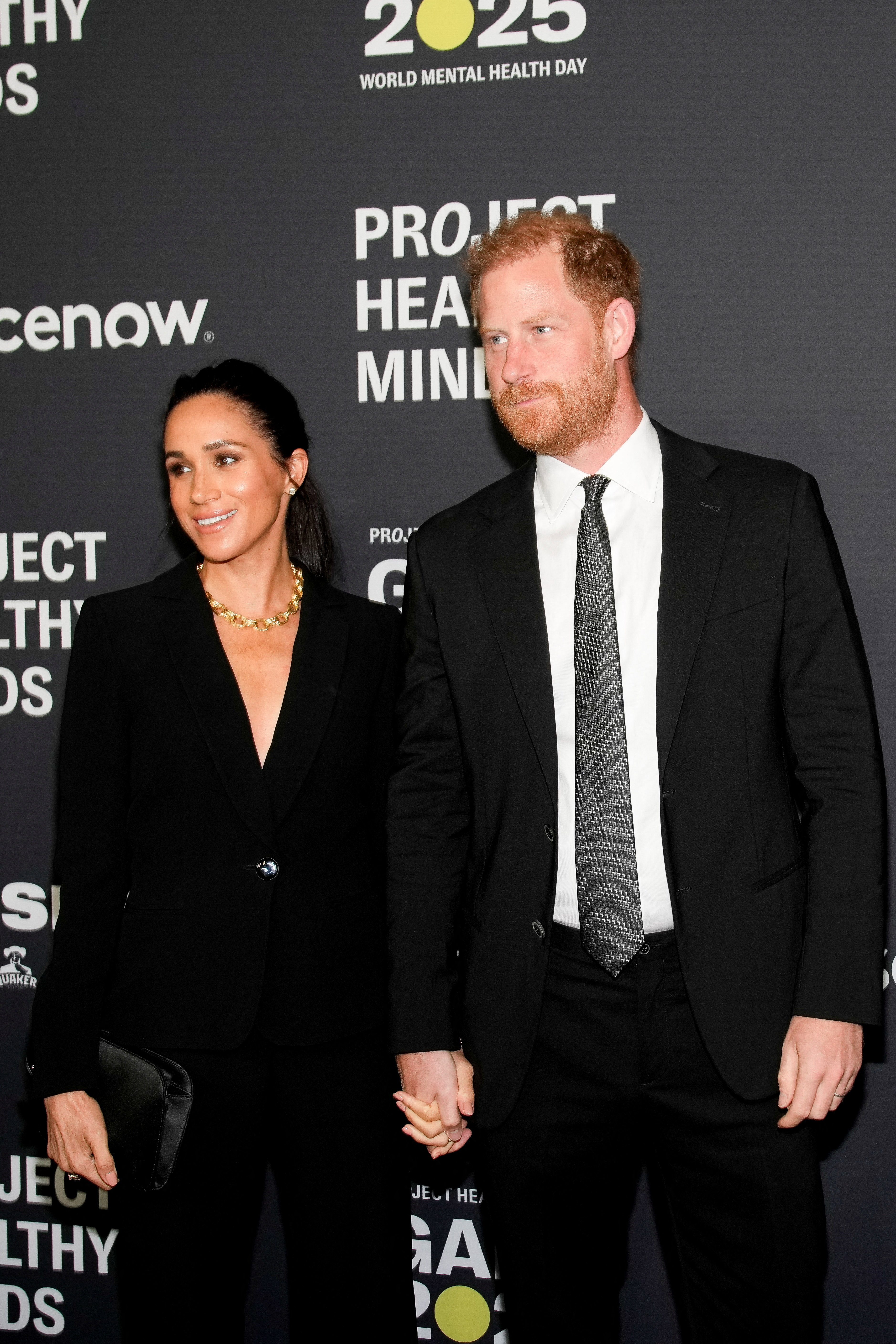 Meghan Markle and Prince Harry engaging with guests.