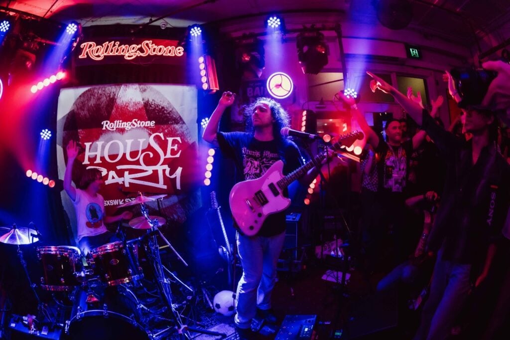 Energetic atmosphere at the house party with crowd enjoying the music