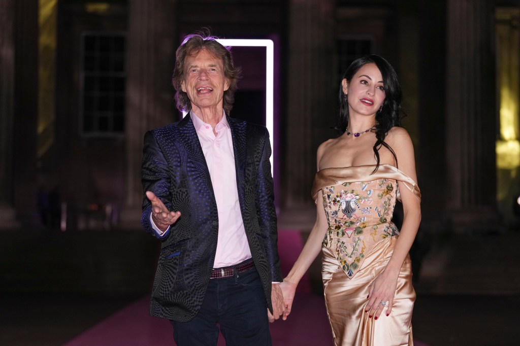 Mick Jagger and Melanie Hamrick pose for photographers.