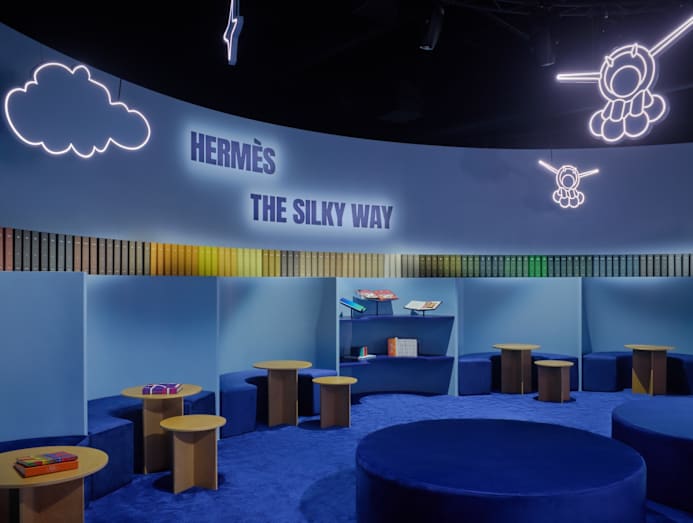 Library corner featuring books on silk scarves and Hermes history.