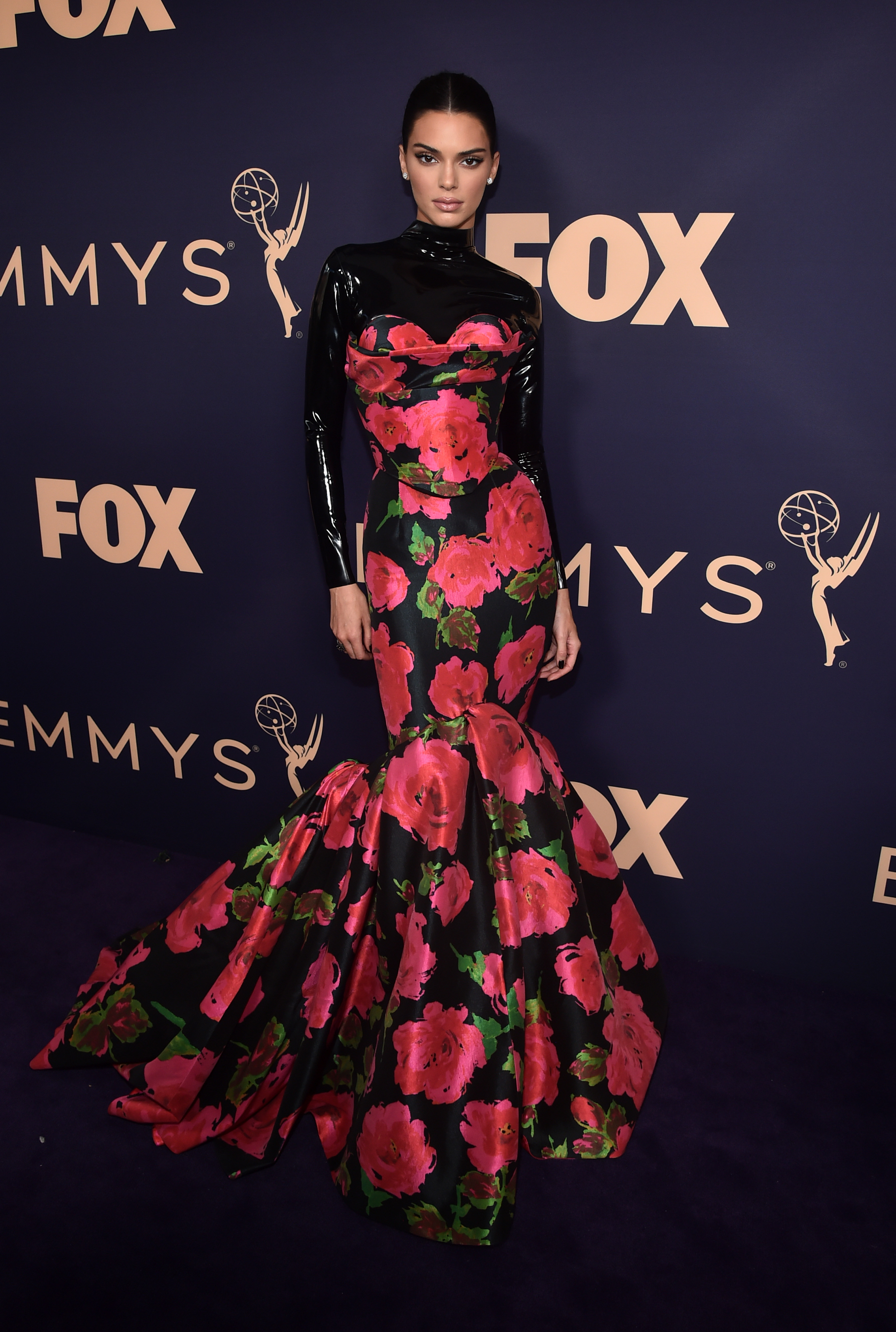 Kendall Jenner in a striking ensemble featuring a latex top and floral gown at the Emmy Awards.